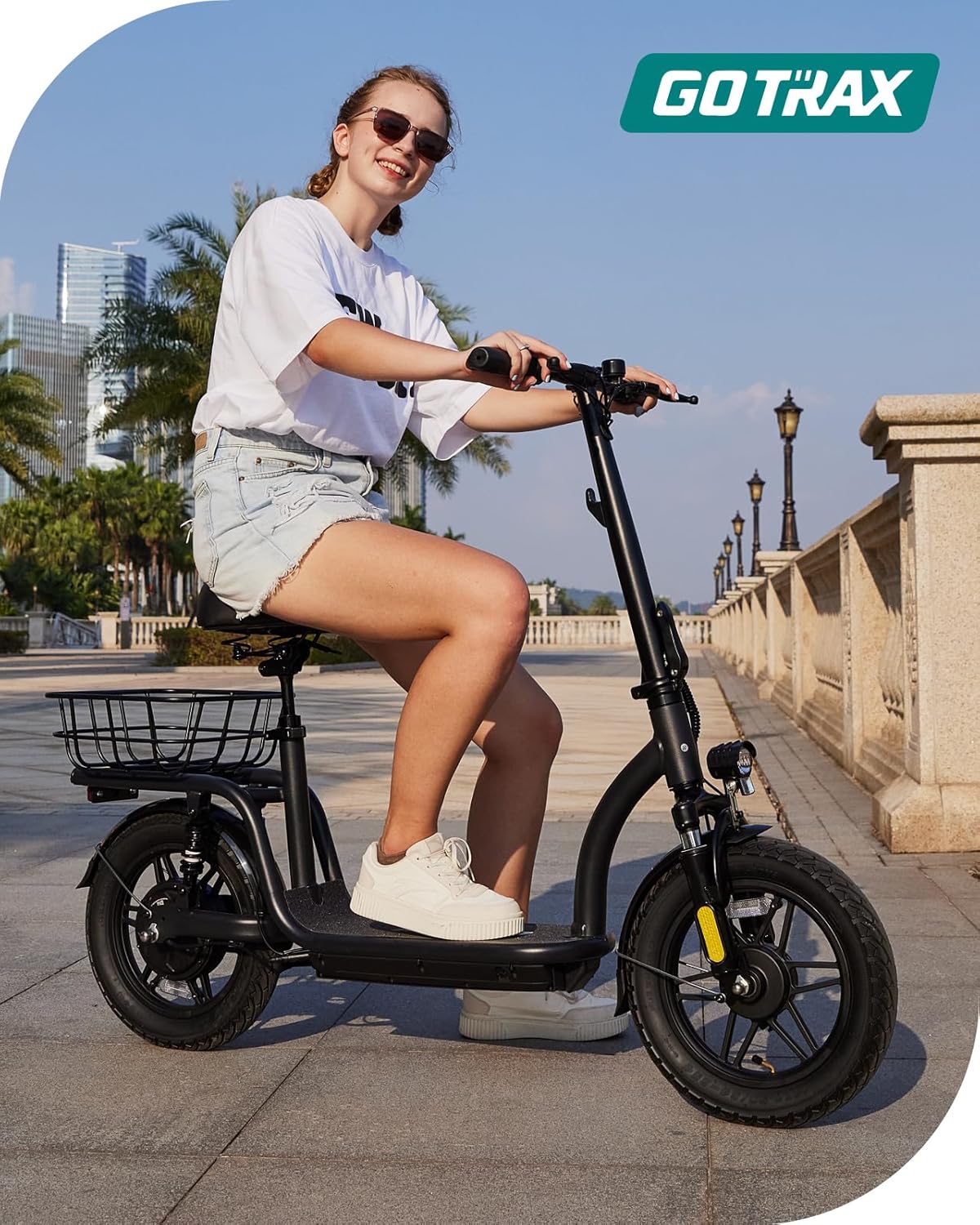 Gotrax adult electric scooter with seat, maximum range of 19-25 miles, all-terrain tires, wide pedals, padded seat, and carrycot